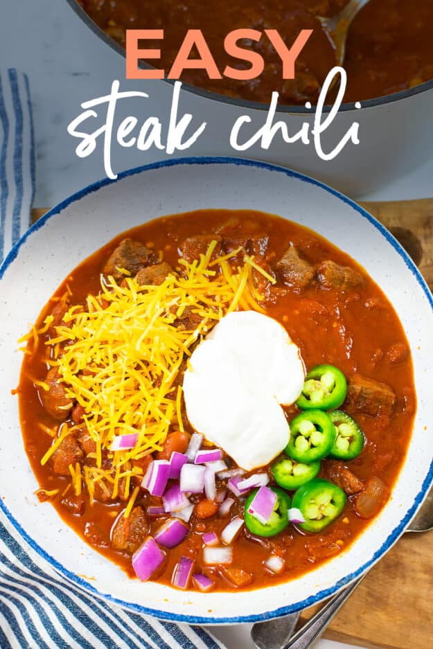 Chili with steak in white bowl.
