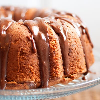 A close up of pound cake on clear glass cake stand