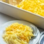 Hashbrowns on a white plate with a fork.