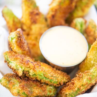 avocado fries surrouding a bowl of ranch dip.