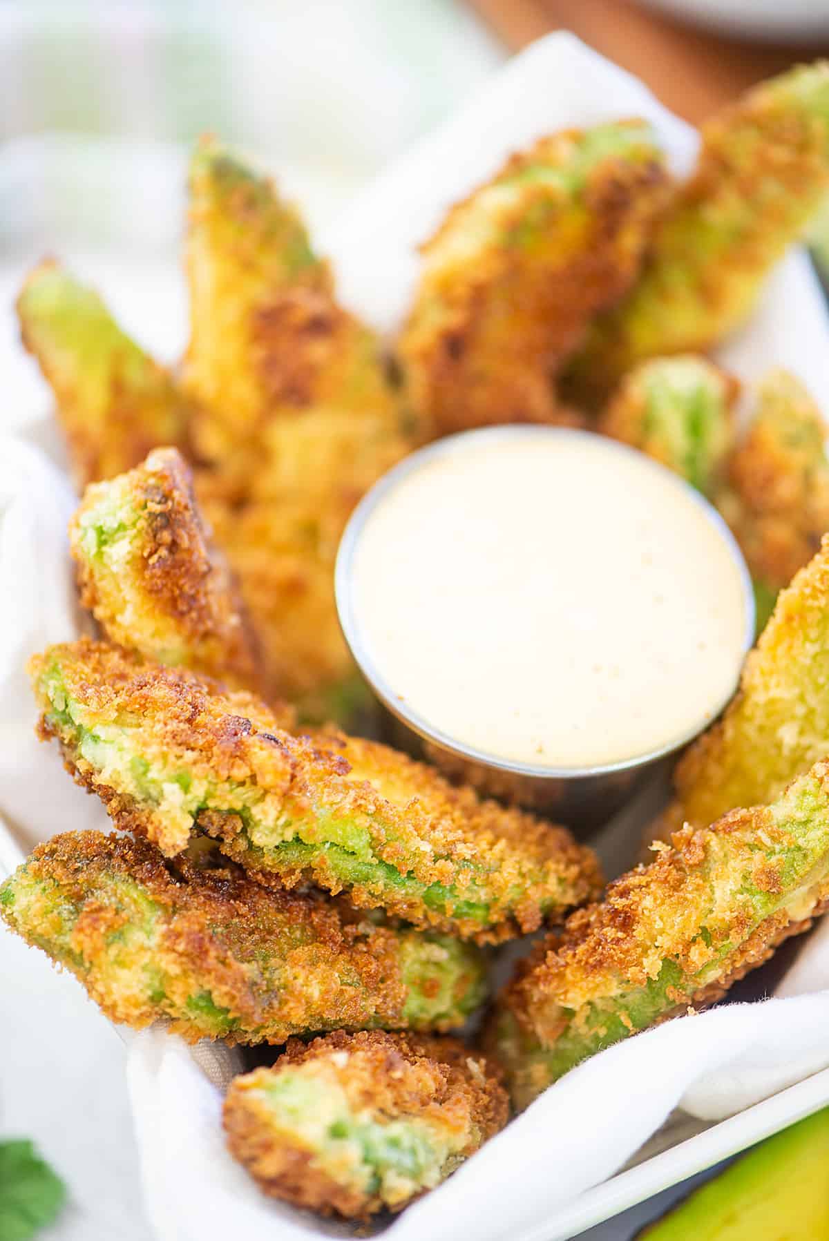 avocado fries surrouding a bowl of ranch dip.