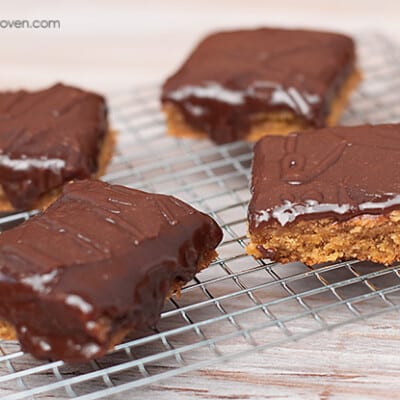 A close up of a peanut butter bar with chocolate frosting.