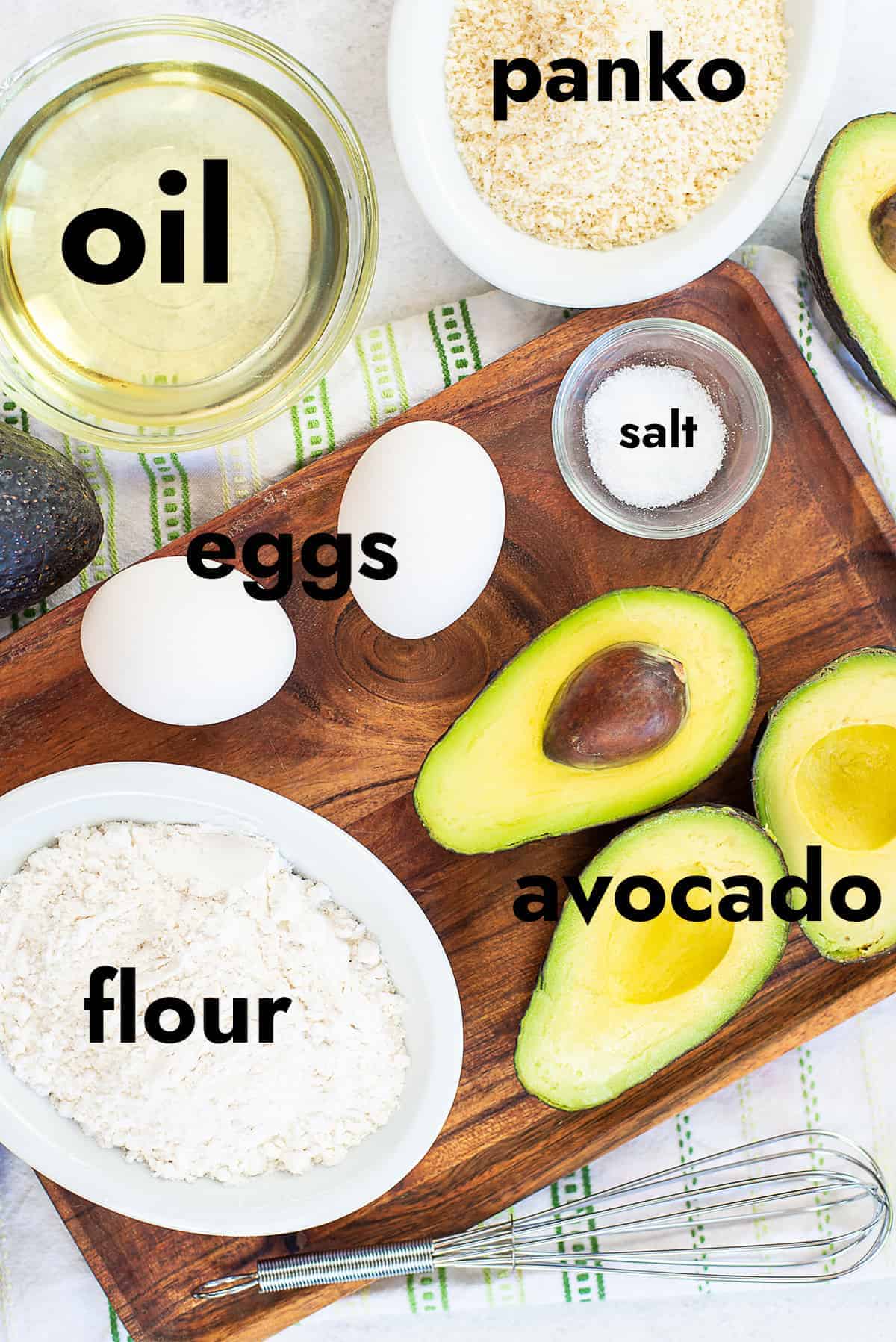 ingredients for avocado fries on wooden board.