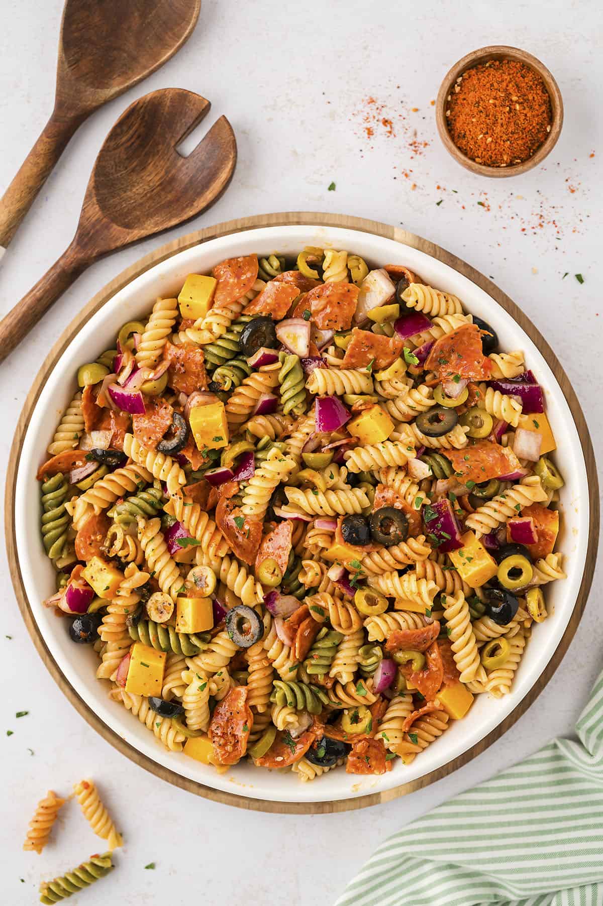 Cold pasta salad in white bowl.