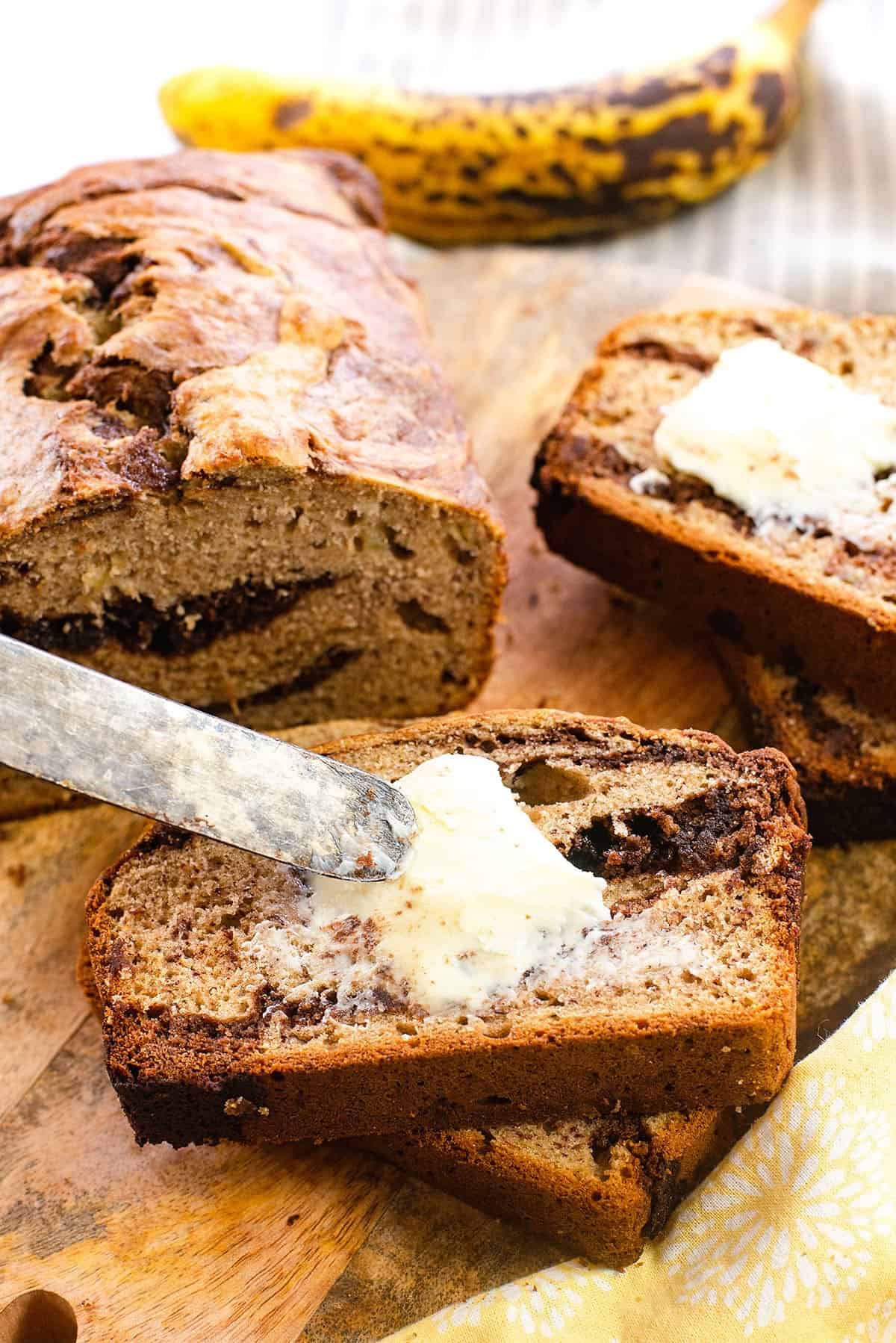 butter spread on slice of banana bread.