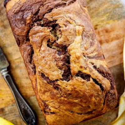 Nutella banana bread loaf of wooden board.