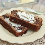 A piece of banana bread with a butter spread.
