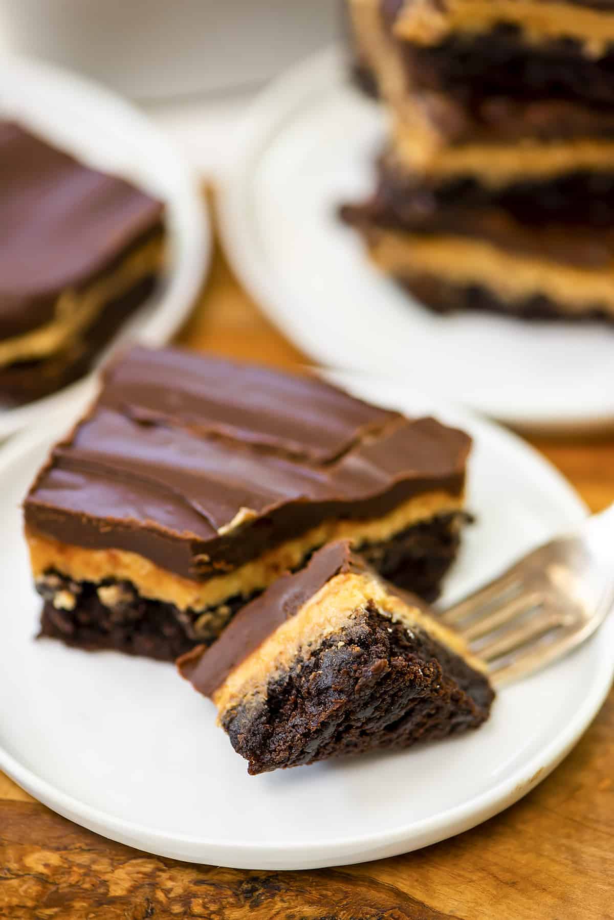 Brownie on a plate with a bite taken out.