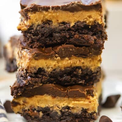 Stack of buckeye brownies on small white plate.