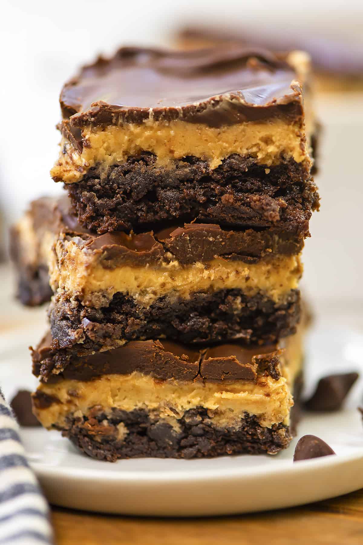 Stack of buckeye brownies on small white plate.