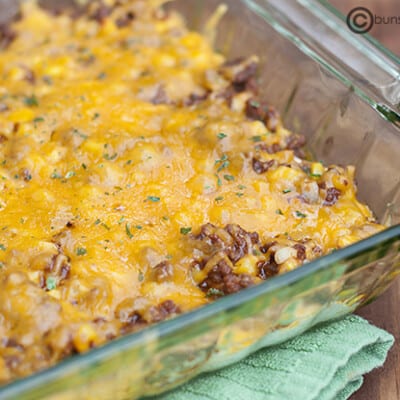 A clear glass baking pan of sloppy joe casserole.