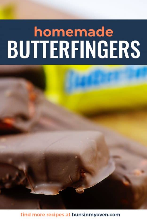 Butterfinger candy bars piled on cutting board.