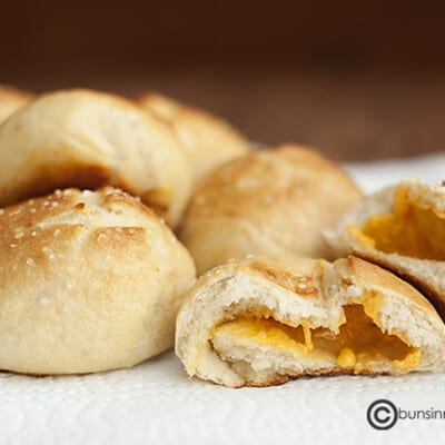 A close up of cheese stuffed pretzel rolls