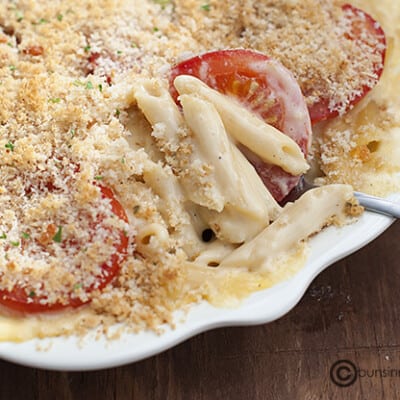 A pan of baked mac and cheese with tomatoes
