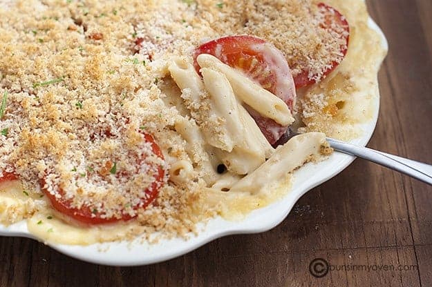 A pan of baked mac and cheese with tomatoes