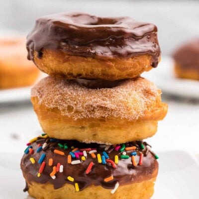 stack of donuts on white plate.