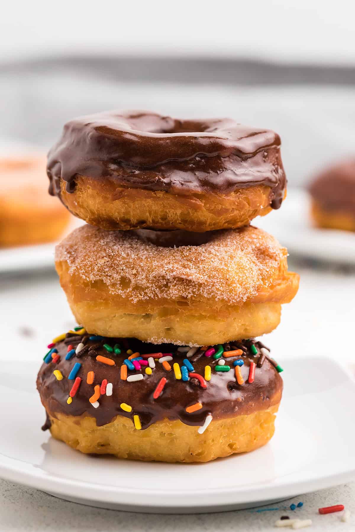 stack of donuts on white plate.