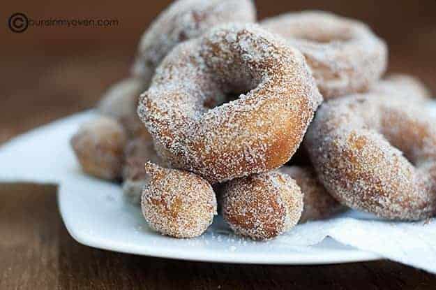 Cinnamon and sugar biscuit donuts with donut holes piled up