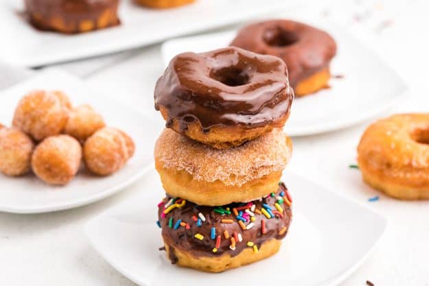 stack of canned biscuit donuts on white plate.