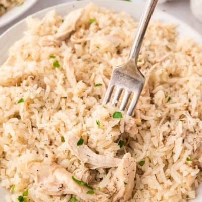 Chicken and rice on plate with fork.