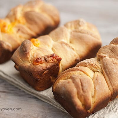 A close up of three pieces of beer cheese bread on a cloth napkin