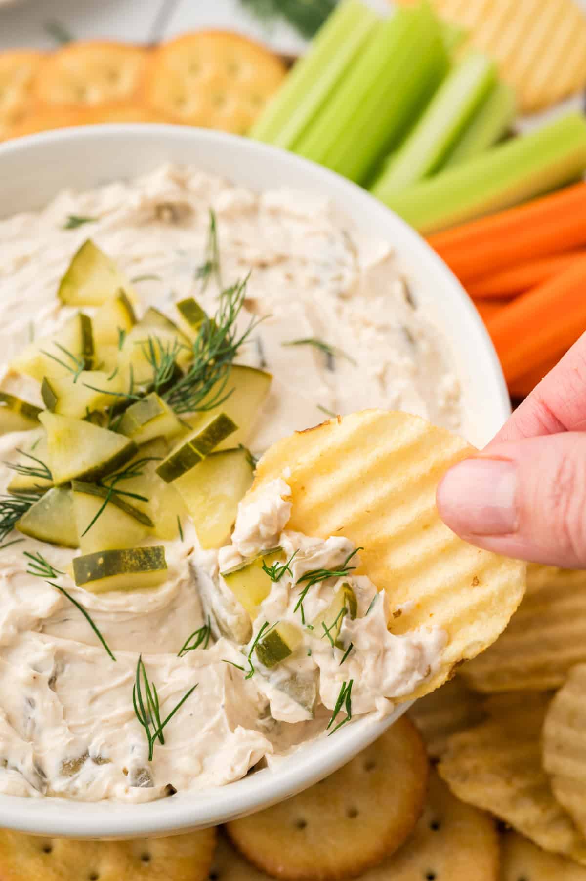 dill pickle dip in small bowls with chips.