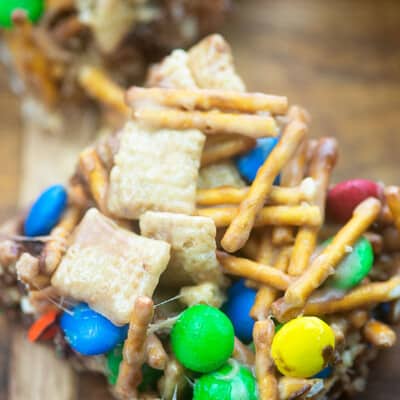 A close up of food a square cereal bar on a cutting board.