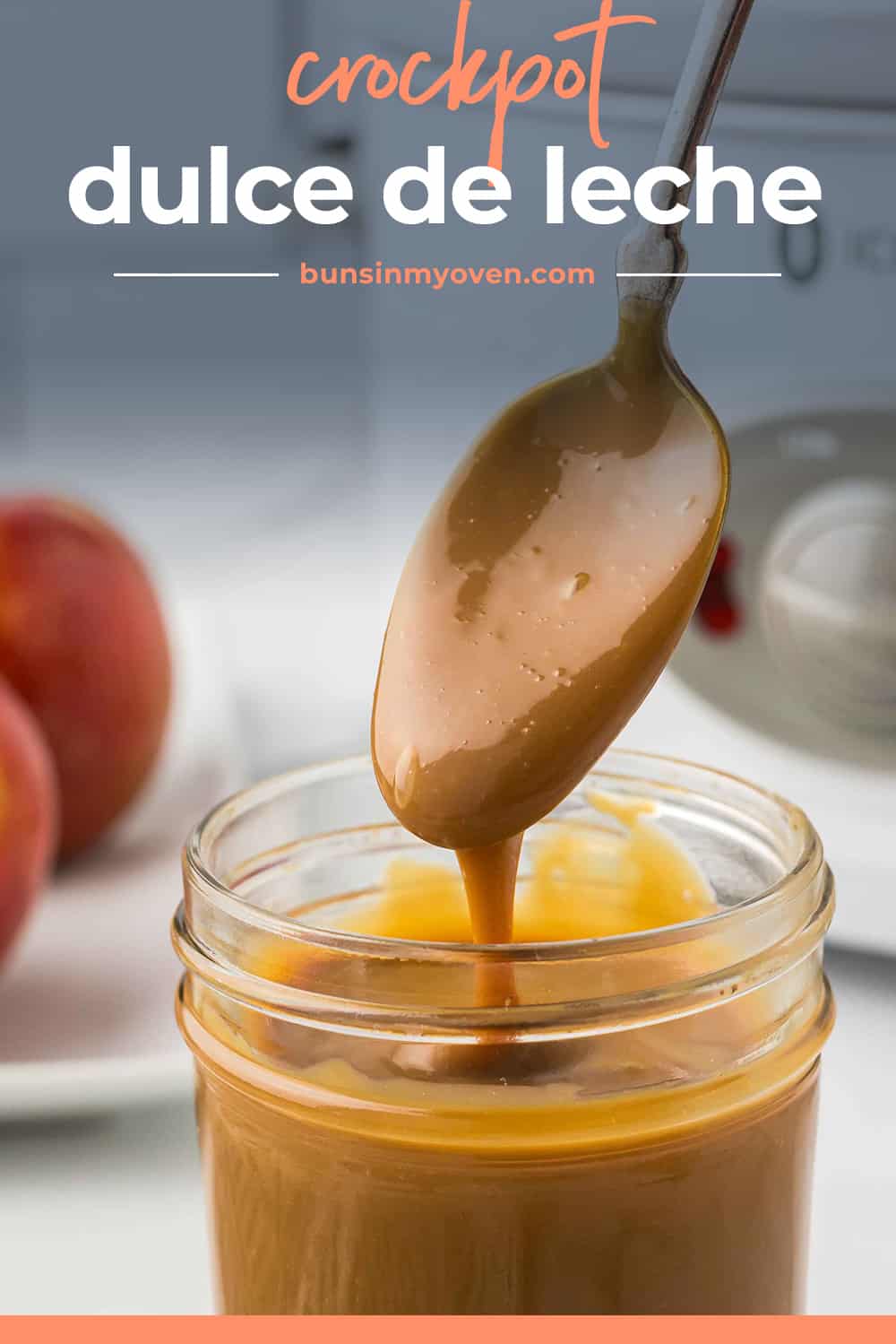 Dulce de leche being dripped off a spoon into a jar.