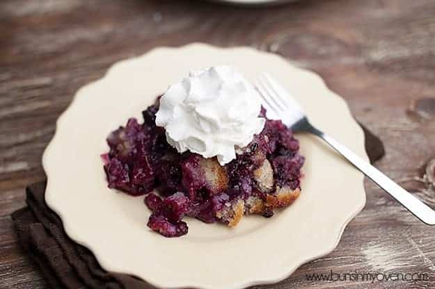 Whipped cream on top of blackberry cobbler