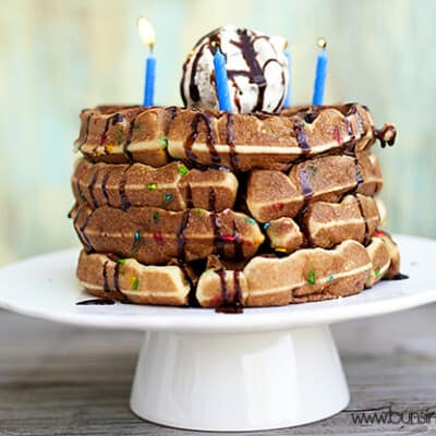 A closeup of waffles with birthday candles on them