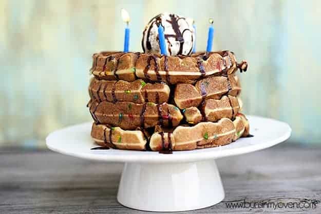 A cake stand with four waffles stacked up on it 