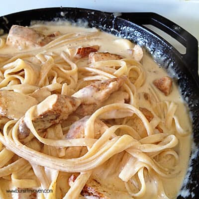 A closeup of chicken Alfredo in a cast iron skillet