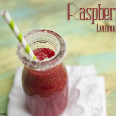 In overhead view of raspberry lemonade and a small milk jar