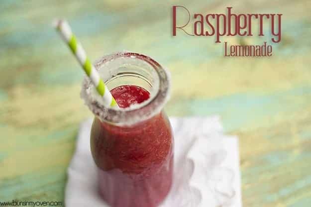 In overhead view of raspberry lemonade and a small milk jar