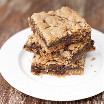 Three cookie bars stacked on a white plate