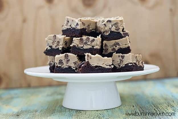 Cookie dough brownies stacked in a pyramid on a cake stand 