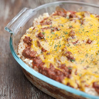 A closeup of a rice bake topped with ground beef and shredded cheese