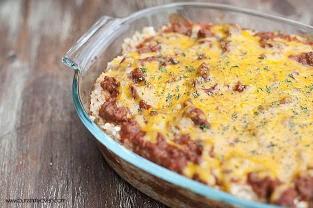 A closeup of a rice bake topped with ground beef and shredded cheese