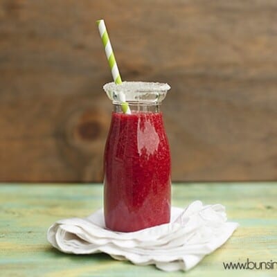 Raspberry lemonade in a small glass milk jar