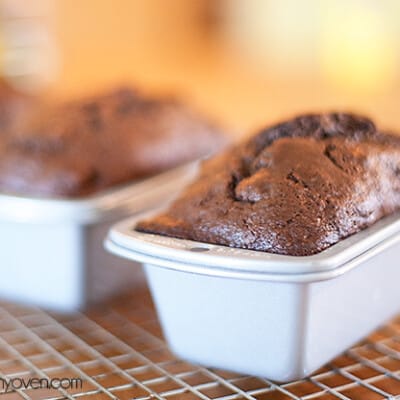 A loaf of chocolate banana bread in a bread pan