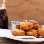 A plate of corn dog bites on a table