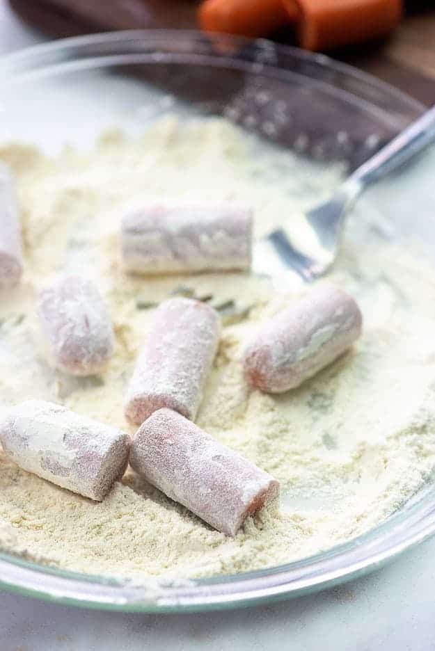 hot dogs coated in flour in glass pan