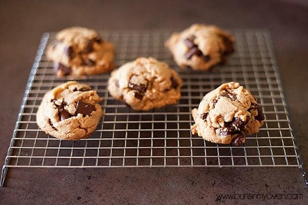 Five peanut butter chocolate chip cookies on a cooling rack 