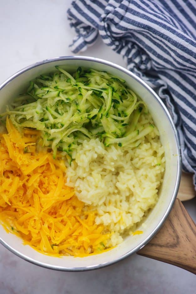 pan with rice, cheese, and zucchini