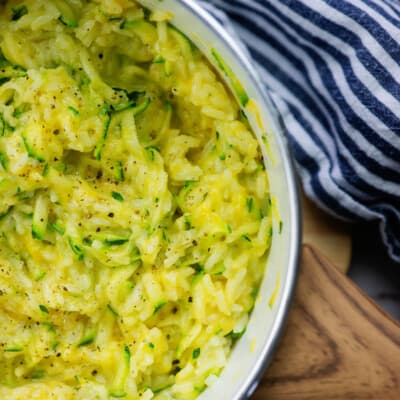 rice in white pot with cheese and zucchini