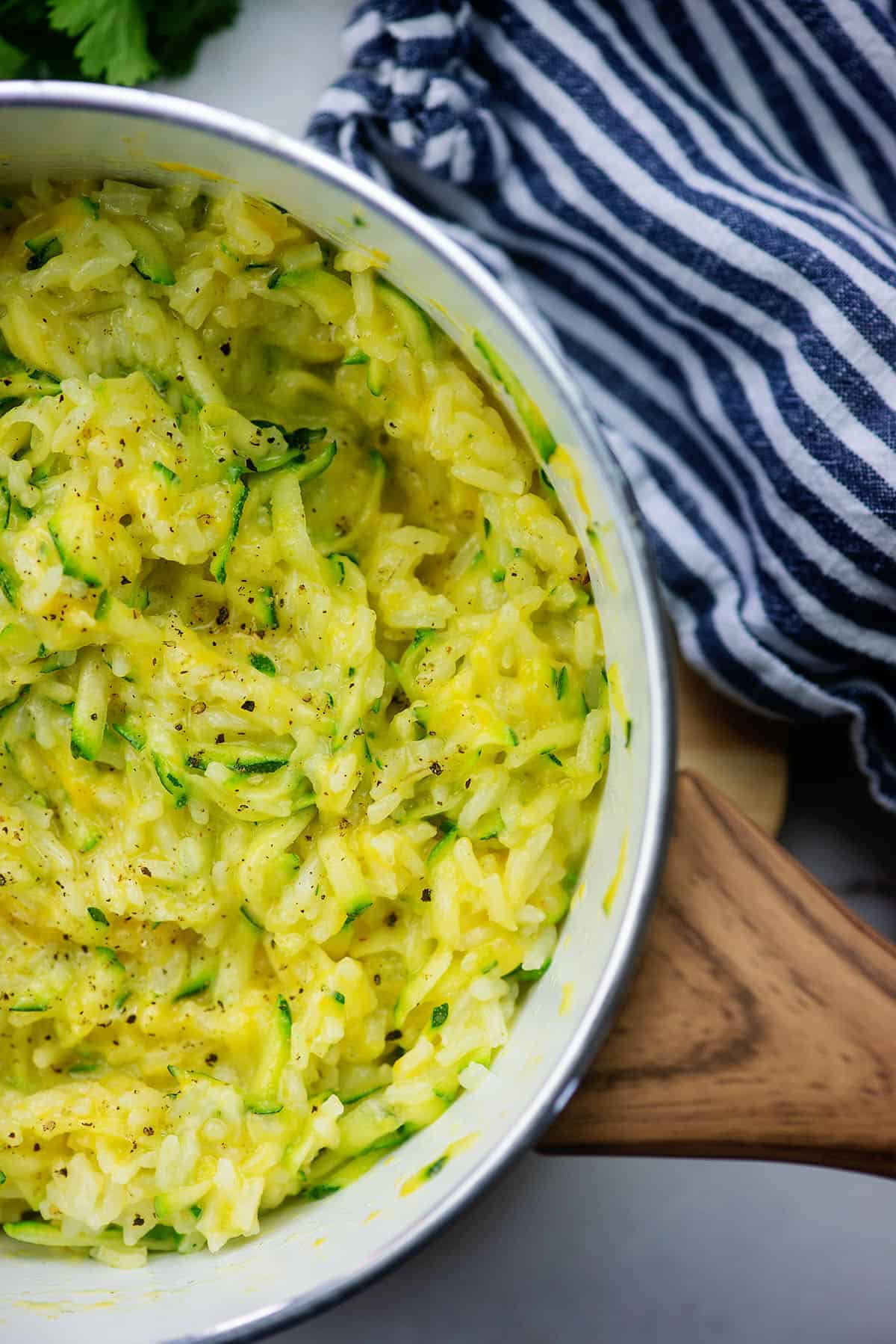 rice in white pot with cheese and zucchini