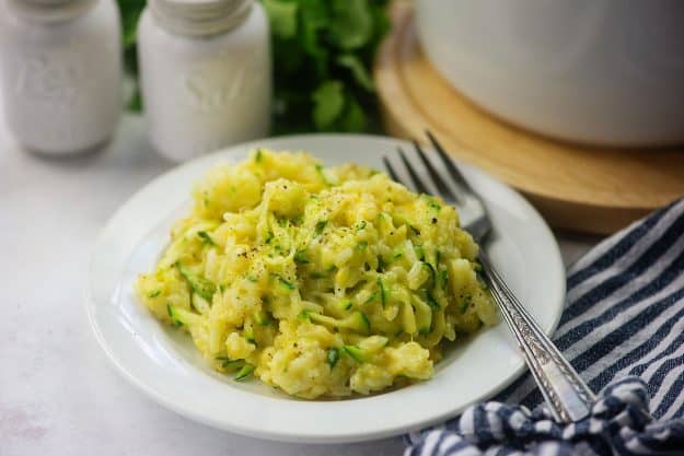 rice with cheese and zucchini on white plate