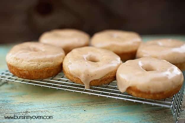 A close up of six brown butter glazed donuts on a cooling rack.