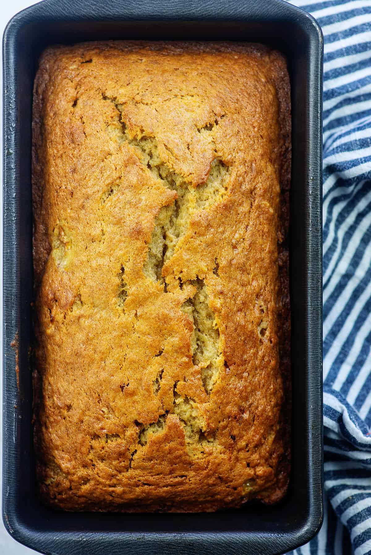 metal loaf pan with banana bread inside