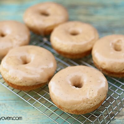 Six brown butter glazed donuts on a  wire cooling rack.